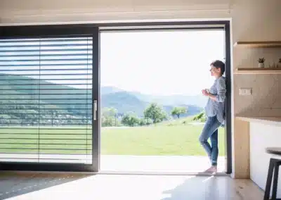 Stacking doors woman with coffee enjoying fabulous view